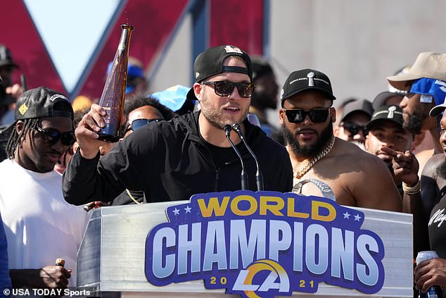 Matthew Stafford raises a bottle to cheer on Rams fans attending Wednesday's rally in LA