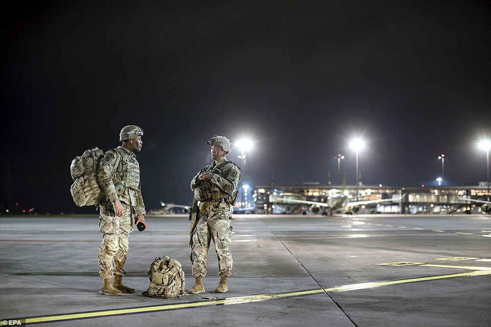 Two of the first 40 soldiers of the 173rd Airborne Brigade of the US Army are seen in Riga after getting off a military plane