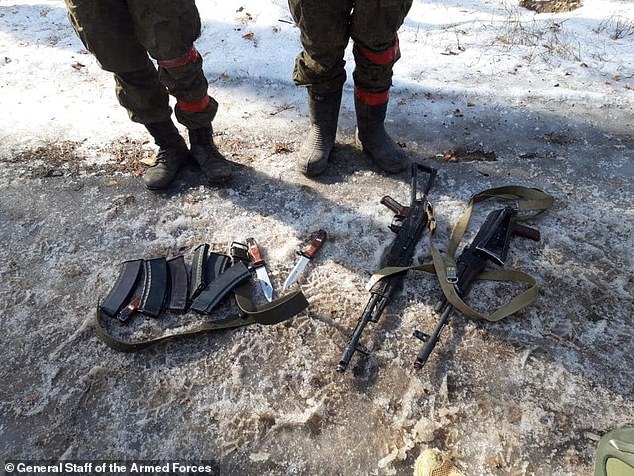 Weapons and knives seized from two Russian soldiers captured by Ukrainian troops fighting around Kharkiv