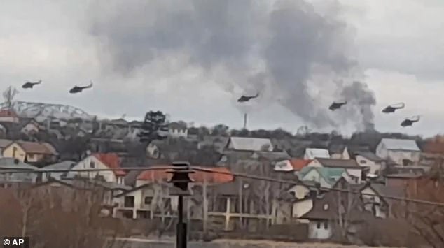 Hours later, bombs and rockets rained down on Ukraine.  Pictured: Russian Mi-8 attack helicopters storm Gostomel air base, right on the outskirts of Kiev