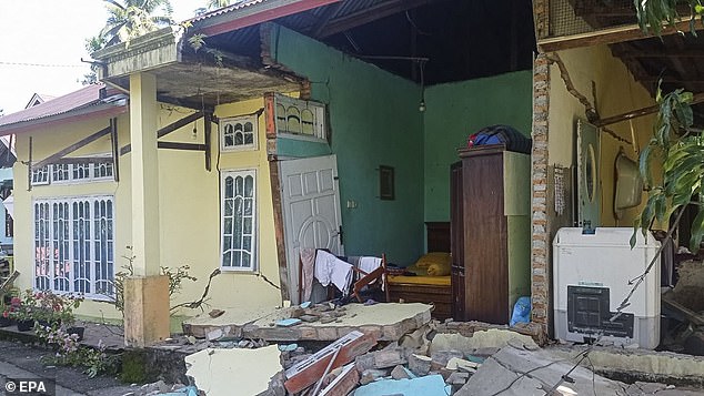 Authorities said there was no danger of a tsunami, but warned of possible aftershocks (pictured buildings collapsed after a magnitude 6.2 earthquake that shook Indonesia on Friday).