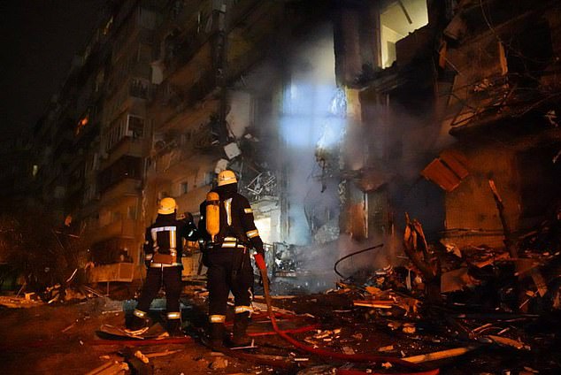 Firefighters are spotted reacting to a fire in a residential building in Kiev in the early hours of Friday