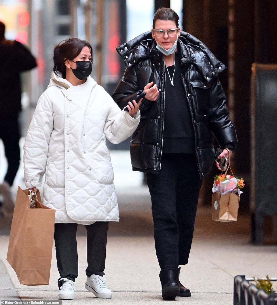 Out with a friend: The star was seen carrying flowers as she strolled with another woman