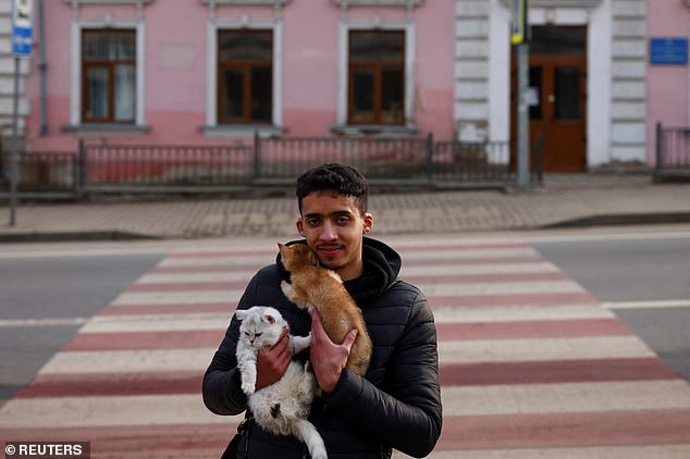 Pictured: Moroccan medical student flees Russia's invasion of Ukraine, bringing his cats Stella and Santa Claus with him as he moves to Poland