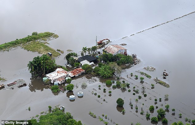 uburbs from Pullenvale to Mt Crosby in Brisbane's west could be cut off for days due to rising floodwaters and dangerous conditions (pictured, a farm house in floodwaters in Bli Bli)