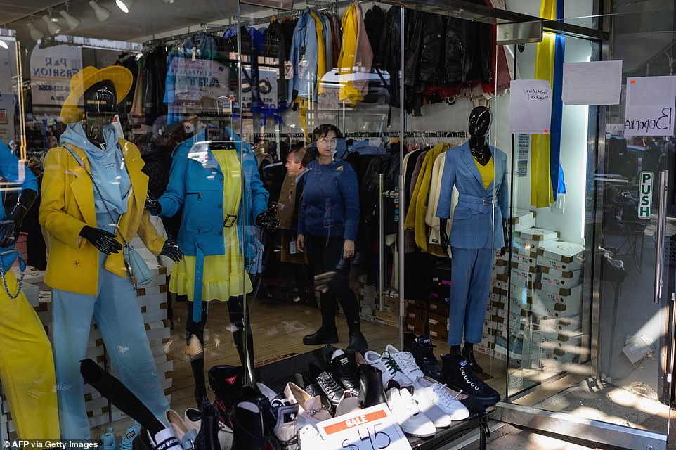 Mannequins in a shop window are dressed in the yellow and blue colors of the Ukrainian flag in Brighton Beach.