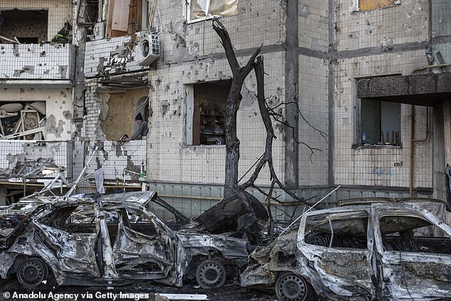 A civilian clears rubble from his apartment, damaged in an explosion two days earlier, in a residential area of ​​Kyiv, Ukraine, on Monday.