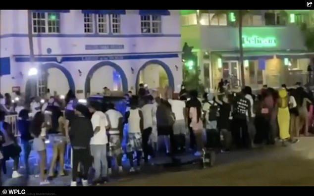 Pictured, a crowd gathers after a spring break shooting on Miami Beach, an incident that prompted city officials to impose a curfew in the form of a state of emergency.