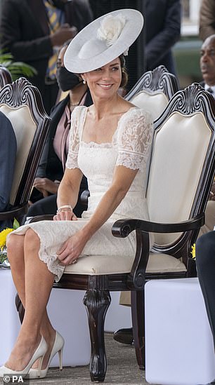 While Her Majesty wore a black tulle hat with three white feathers, the Duchess opted for an all-white floral headpiece.