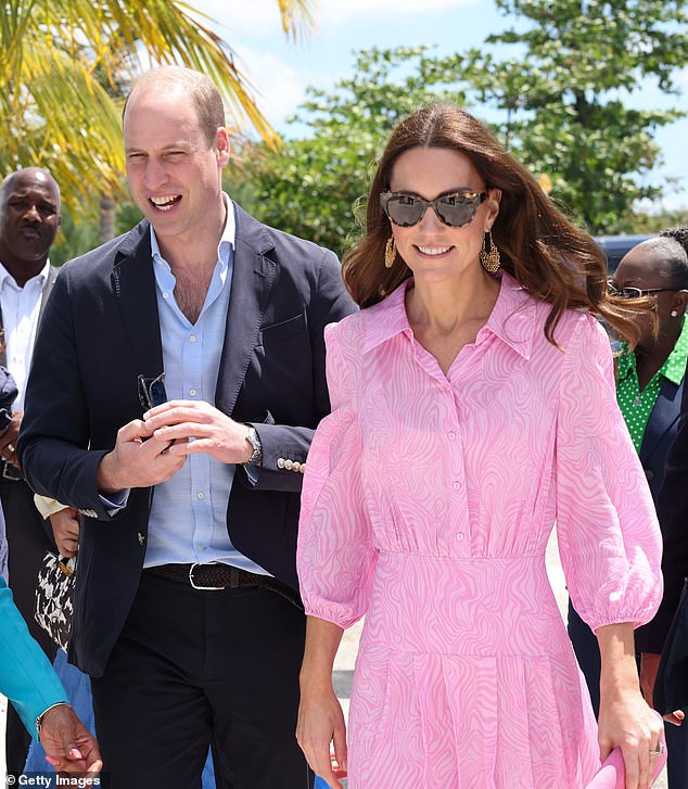 Kate, in a pink dress and sunglasses, walks with Will in a navy blue suit and light blue shirt on a tour of the Bahamas.