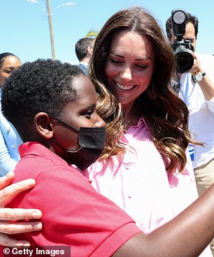 The Duke and Duchess shook hands with well-wishers and told people about the aftermath of the hurricane.  William turned down the opportunity to hold the baby, but agreed to pose next to him