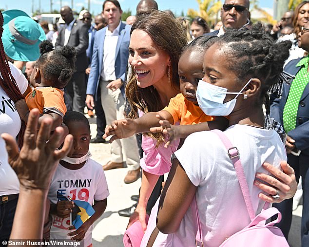 Kate beamed as she mimicked the storm, smiling at countless locals for photos, including several small children.