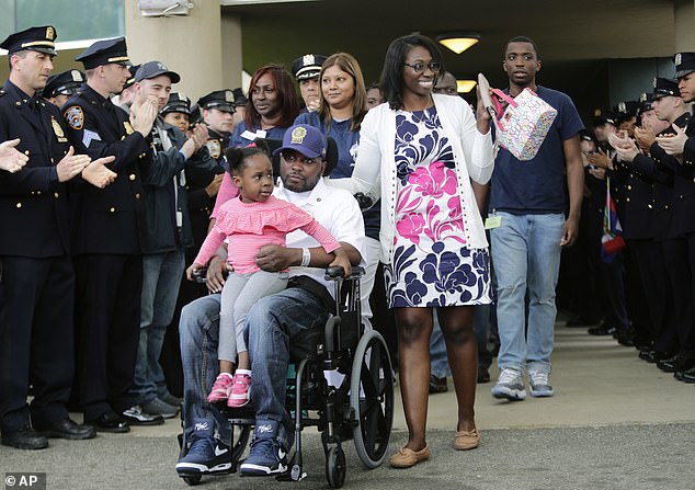 Det. Dalsh Veve is accompanied by his wife Esther daughter Dashi as he exits a rehab facility