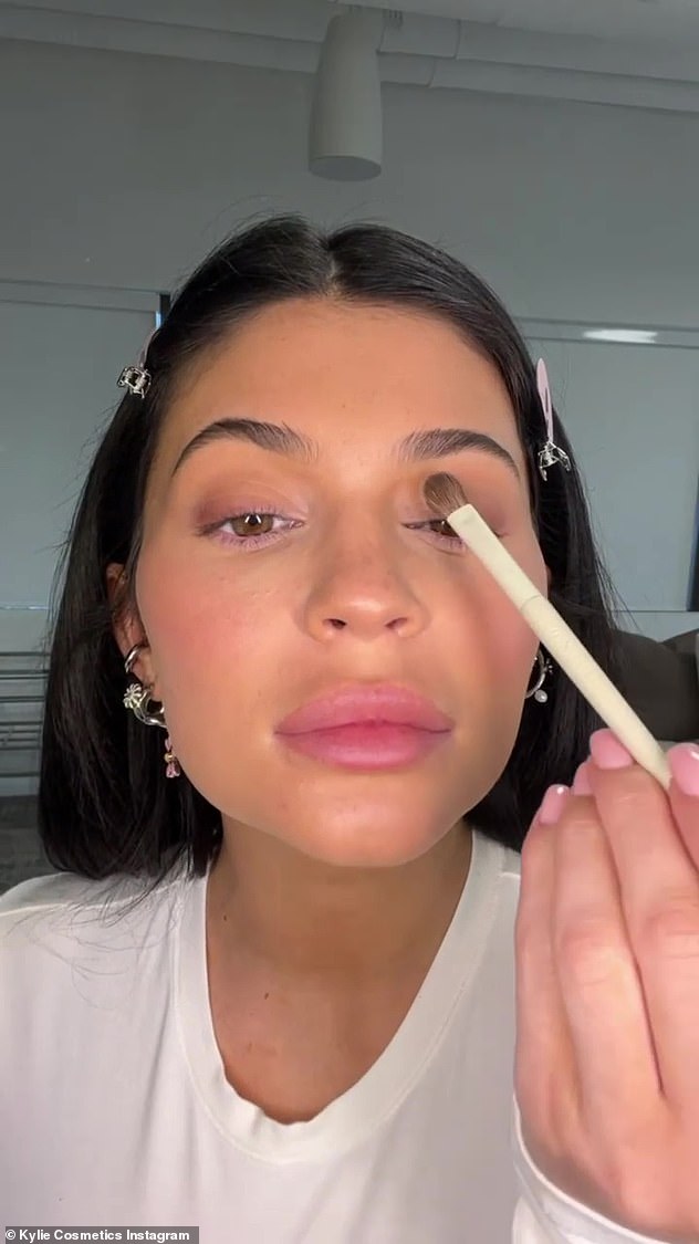 Sultry look: After her face was set with powder, Kylie pulled out the KENDALL X KYLIE eyeshadow palette and dipped her eyeshadow brush in a variety of warm browns and pinks