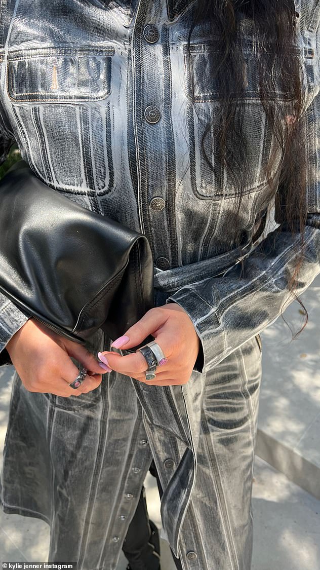 A closer look: The little sister of Kendall Jenner gave fans a closer look at her outfit, adding a closeup of the front of her trench coat with her hands and her clutch in the frame