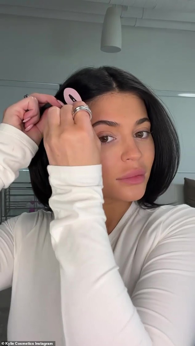 Out of the way: Before diving into makeup, Kylie used a pair of clips to get her hair out of the way