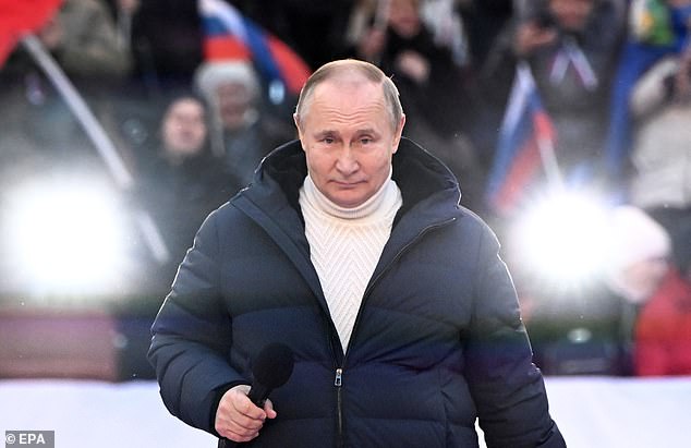 Russian President Vladimir Putin attends a concert marking the 8th anniversary of Crimea's reunification with Russia at Luzhniki Stadium in Moscow, Russia, March 18, 2022