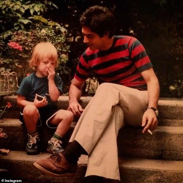 Daniel is pictured with his father as a young boy in a touching photo posted to his Instagram account, captioned 