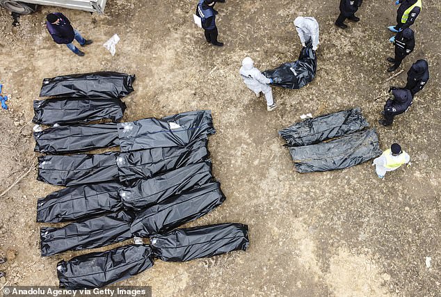 An aerial view of officials continues to exhume the bodies of civilians who died during Russian attacks in Bucha earlier this month