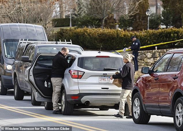 An officer was seen carrying a paper bag out of the house on Thursday morning