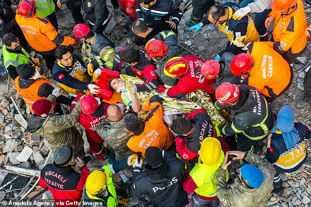 A 12-year-old child is rescued by workers from the rubble of a collapsed building in Hatay's Antakya district