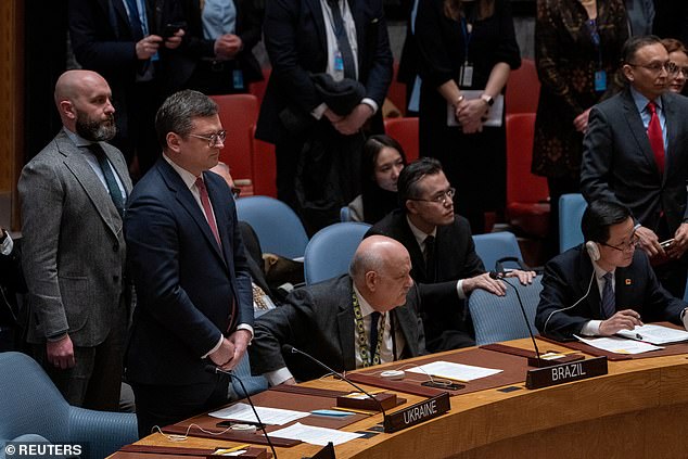 Pictured: Ukraine's Foreign Minister Dmytro Kuleba and other officials stand for a minute's silence during a United Nations Security Council meeting to mark the year-long Russian invasion of Ukraine.  However, the gesture was interrupted by Russia's representative