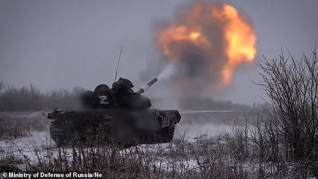 Russian T-72B3 tanks fire on Ukrainian fortified positions in Ukraine in undated footage.