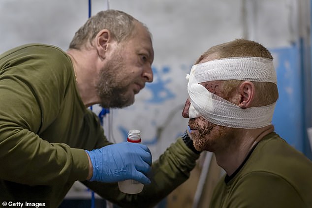 A doctor from the Ukrainian Army's 72nd Mechanized Brigade treats a soldier at a stabilization hospital near the front lines in the Donbass region of eastern Ukraine.