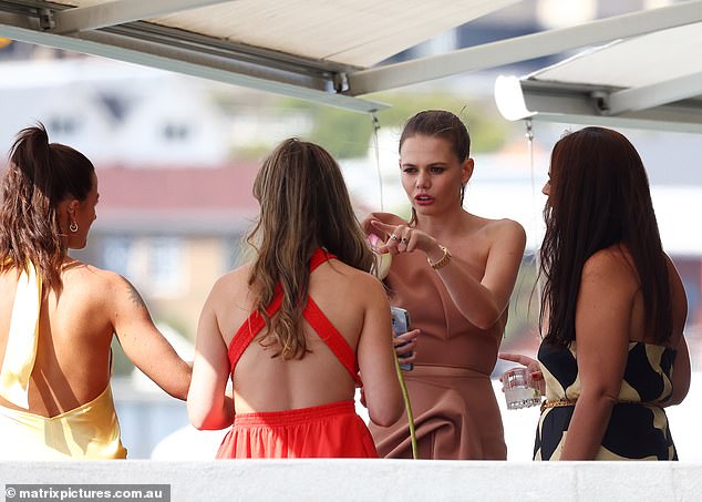 Lucia was spotted laughing and joking with her colleagues while sipping cocktails on the waterfront veranda