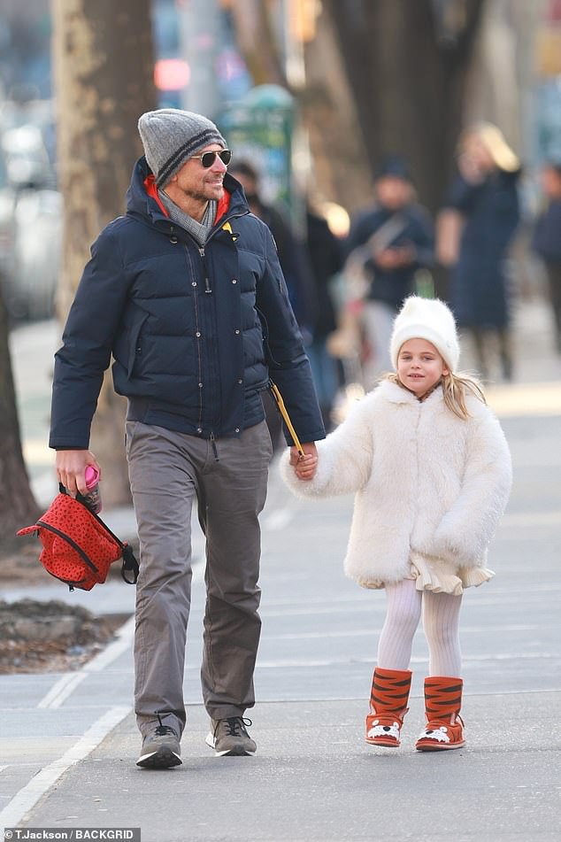 Bradley Cooper holds hands with daughter Lea five during an