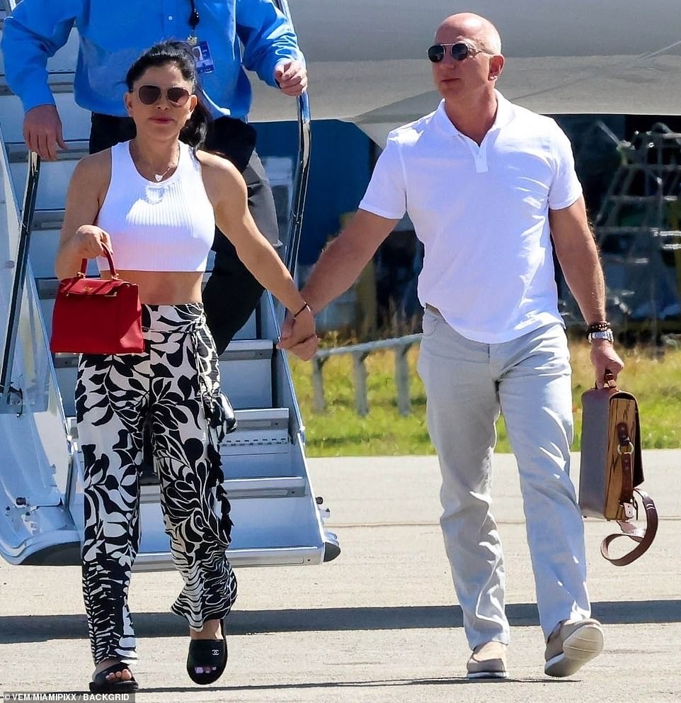 Casually dressed Jeff Bezos and Lauren Sanchez land on a