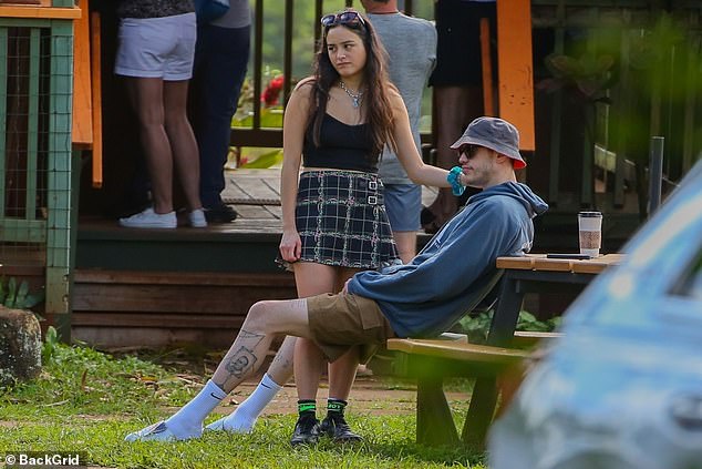 Relaxed: Pete wore a gray bucket hat and long white Nike socks with white mules