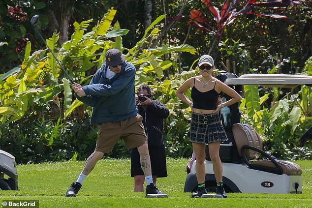 Working on his swing: Pete was pictured intensely practicing his golf swing