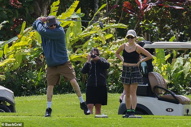 Chic girl: Chase showed off her toned legs in a plaid mini skirt and flashed a hint of her tiny waist in a black crop top