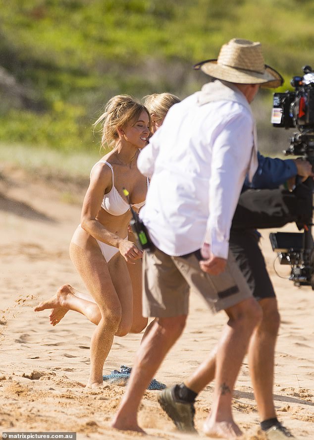 A group of cameramen and crew members filmed the action from the beach