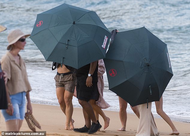 When filming was over, the producers rushed to wrap the stars in towels and hide them behind a wall of Bunnings Warehouse umbrellas