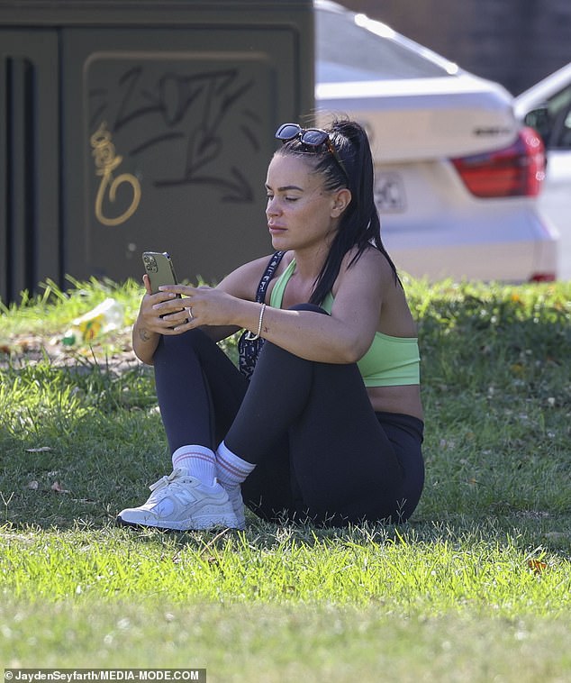 Bronte, 28, didn't lose sight of her phone as she held it in her hand for most of the walk.  Later she sat in the shade and under a tree to send an important text message