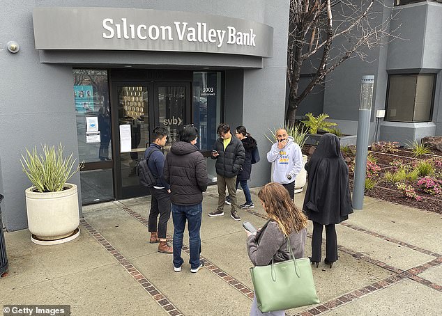 People queue in front of the closed Silicon Valley Bank (SVB) headquarters on March 10, 2023 in Santa Clara, California