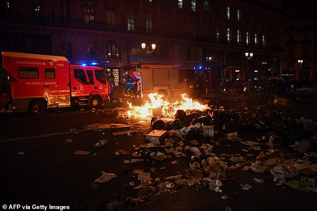 A pile of rubbish burns during a demonstration in Paris on Monday evening