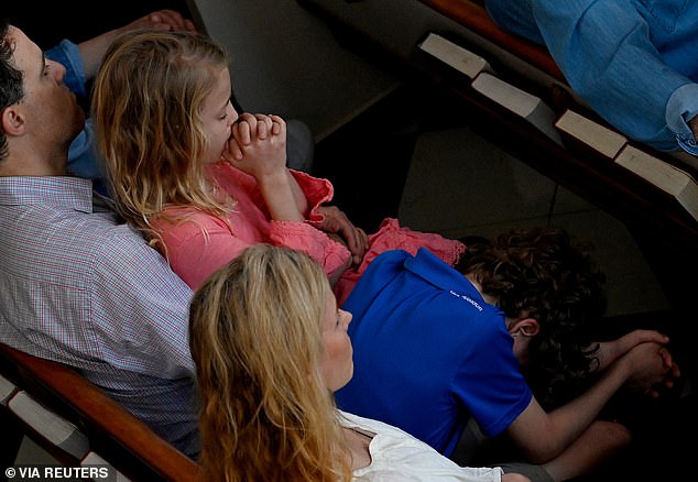 Family members pray for the victims of the mass shooting at Nashville's Covenant School during a vigil at Woodmont Christian Church