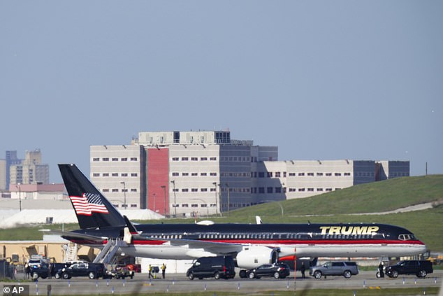 Trump's private plane is parked on the tarmac at LaGuardia Airport, with Rikers Island Jail in the background