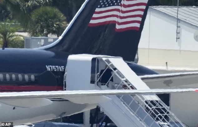 Donald Trump paused, turned and waved as he boarded his plane to fly to New York on Monday afternoon.  He was accompanied for the flight by campaign staff and lawyers