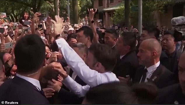 Students mobbed the French President as he strolled across the grounds in front of the University Hall