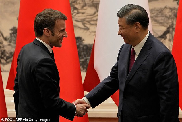 President Xi Jinping (R) shakes hands with his French counterpart Emmanuel Macron after the signing ceremony in Beijing April 6, 2023