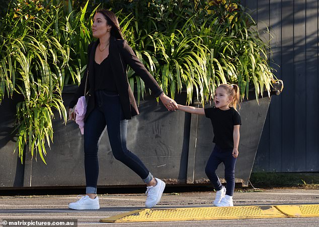 She takes her daughter's hand, which she shares with Jaxon, the I'm a celebrity... Get me out of here!  The Aussie star folded a smaller pink jacket over her handbag