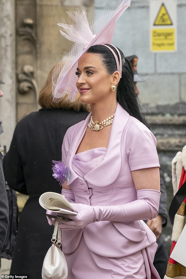 Perry wore a large lilac fascinator that matched her dress, cropped jacket and gloves