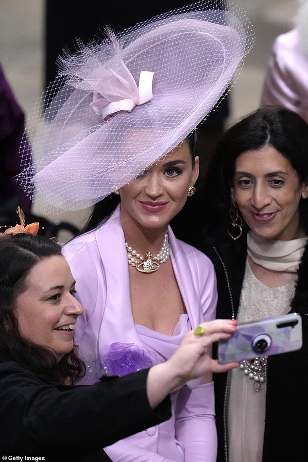 Wearing lilacs and a large Vivienne Westwood pearl necklace, Perry posed for selfies with adoring fans