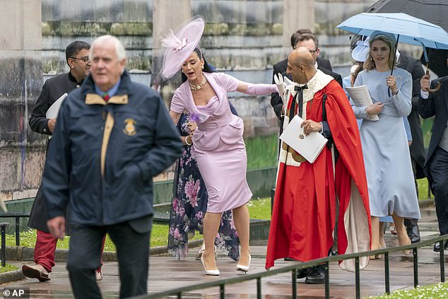 Oops!: Perry stumbles in her white heels as she exits the ceremony