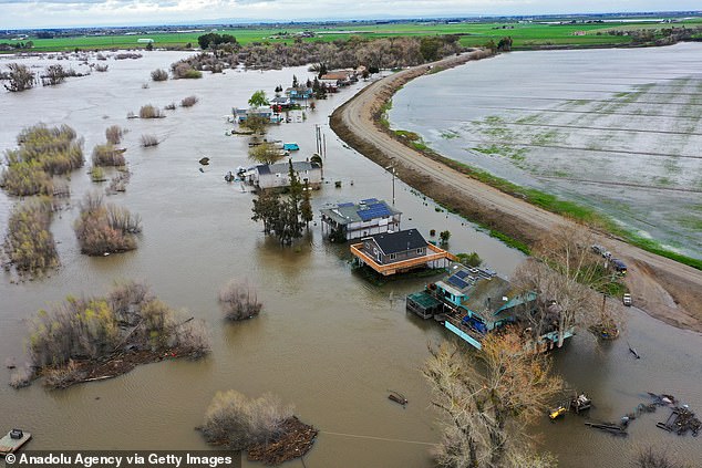 An aerial view shows homes submerged after a levee breached March 21 in San Joaquin County, California.  California has been hit by a series of devastating floods and storms this year