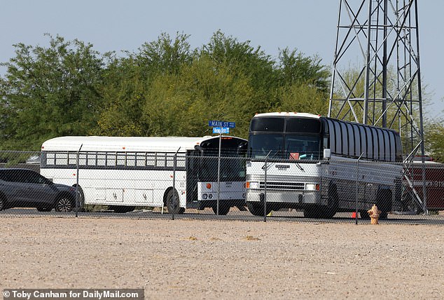 Three white buses with blacked-out windows pulled into the Yuma Public Safety Training Facility near the city's airport on Friday afternoon